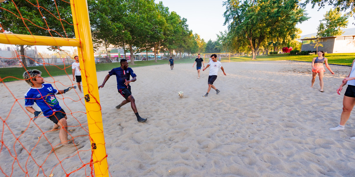 A group of friends playing beach soccer at the Gyro Beach sand courts.