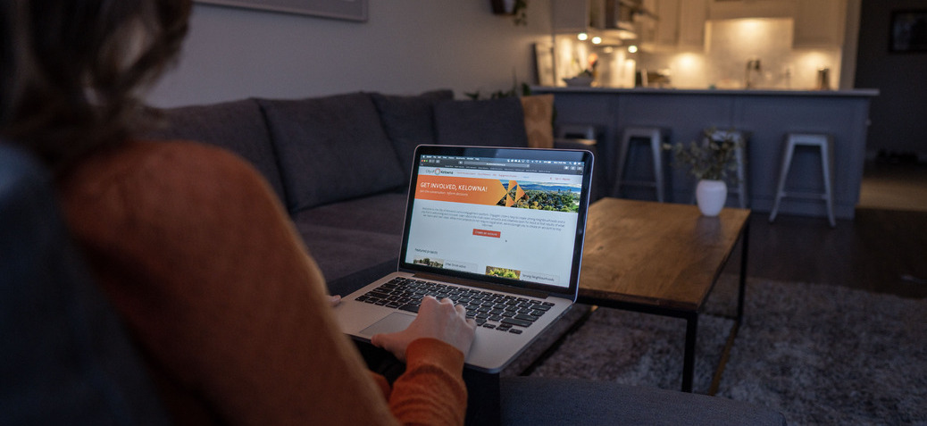 Person accessing an online platform on a laptop in their living room