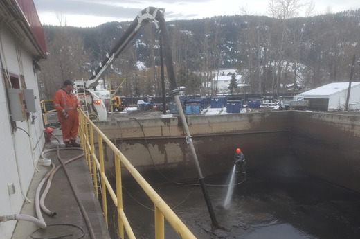 Cleaning debris and silt out of a tank at the Merritt Wastewater Treatment Plant