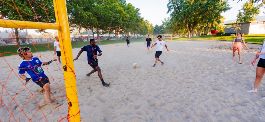 A group of friends playing beach soccer at the Gyro Beach sand courts.