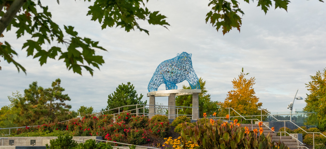 The Bear at Stuart Park surrounded by spring flowers.