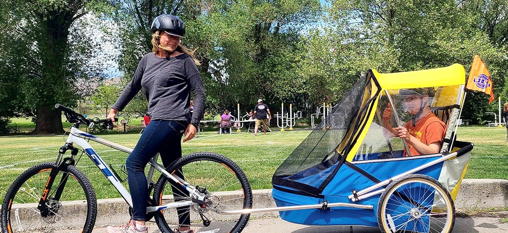 Mom, Karen and 22-year-old Kai try out one of the new adult bike trailers now available 