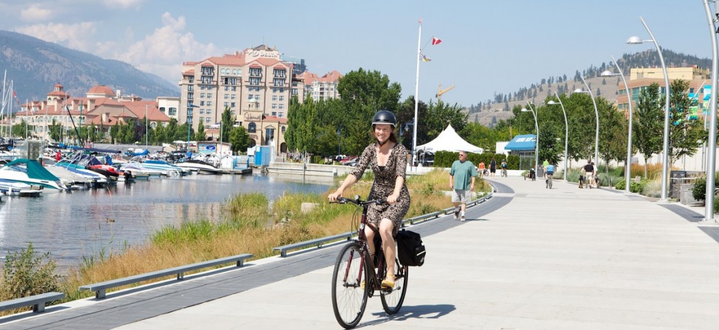Woman riding her bike in downtown Kelowna Woman riding her bike in downtown Kelowna