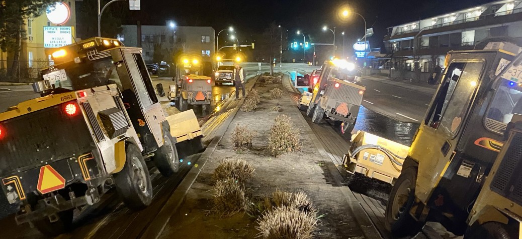 Sweepers clearing the centre median of Highway 97 Sweepers clearing the centre median of Highway 97