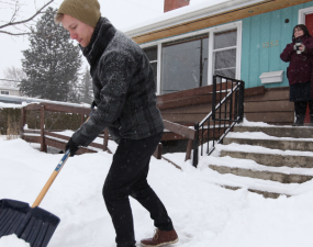 Resident clearing snow